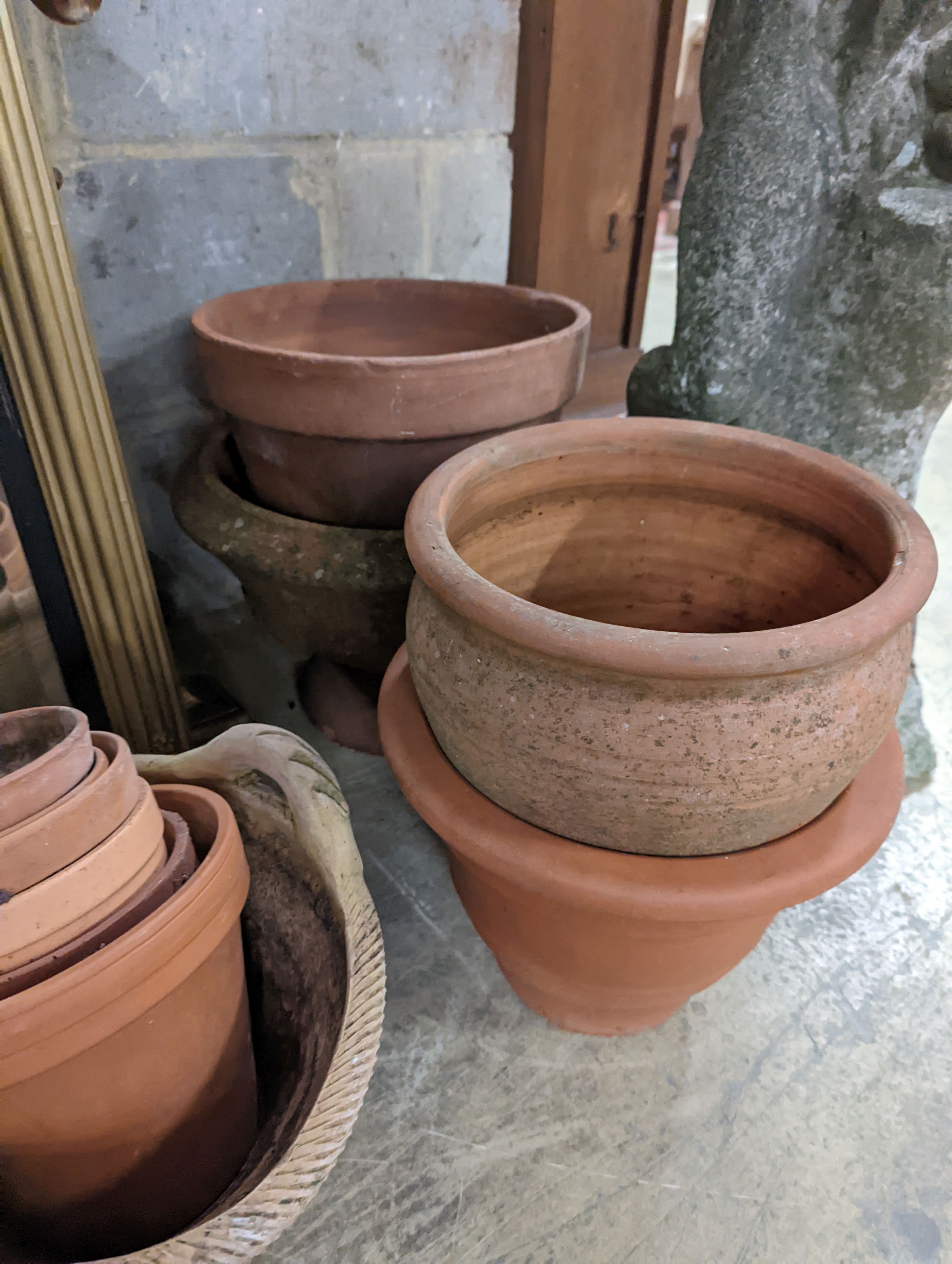 A collection of approximately 20 assorted terracotta garden planters, largest diameter 35cm